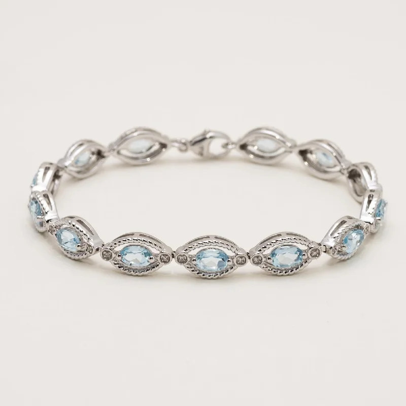 Women’s infinity bracelets-Oval Blue Topaz Bracelet in Sterling Silver with Diamonds (1/10ct tw)